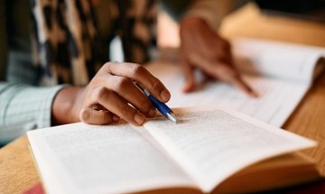 person studying from a book